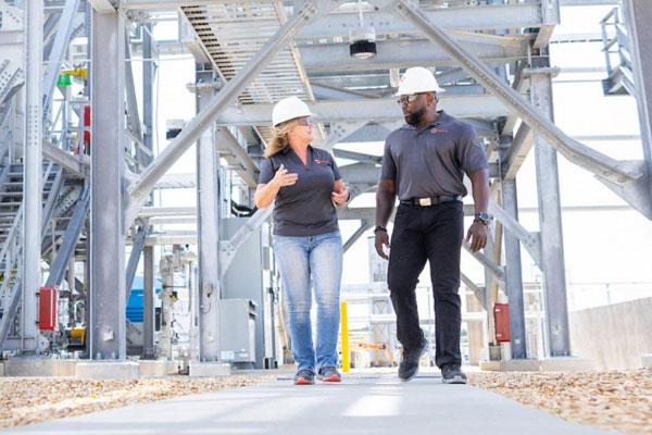 Two employees walking through a facility