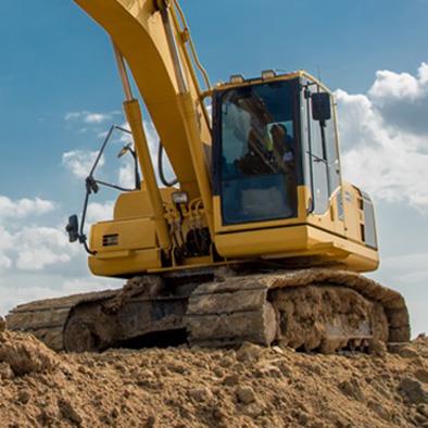 Digger machine on a dirt hill