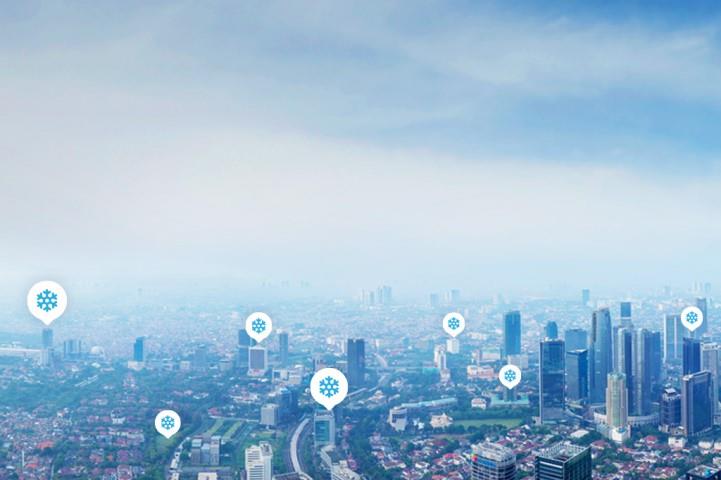 Ariel view of a city with snowflake icons over buildings